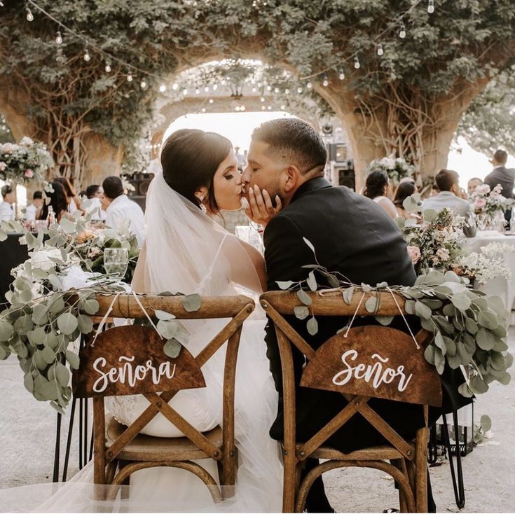 a bride and groom kiss on their wedding day