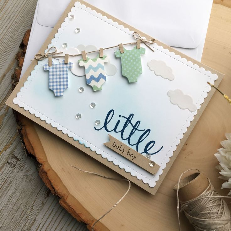 a baby's first birthday card on top of a wooden table next to some twine