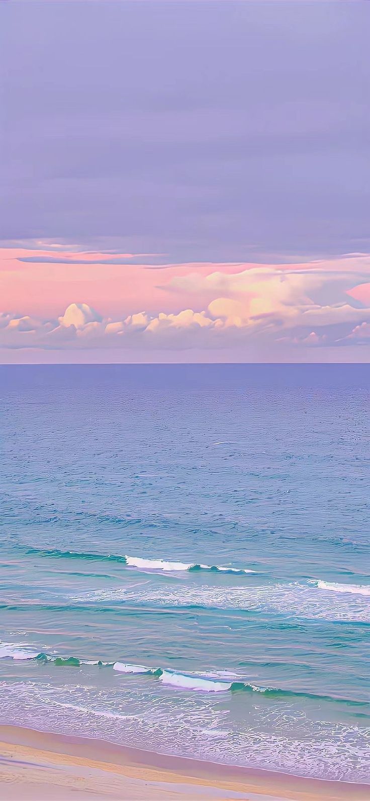 two people walking on the beach carrying surfboards under an overcast sky at sunset