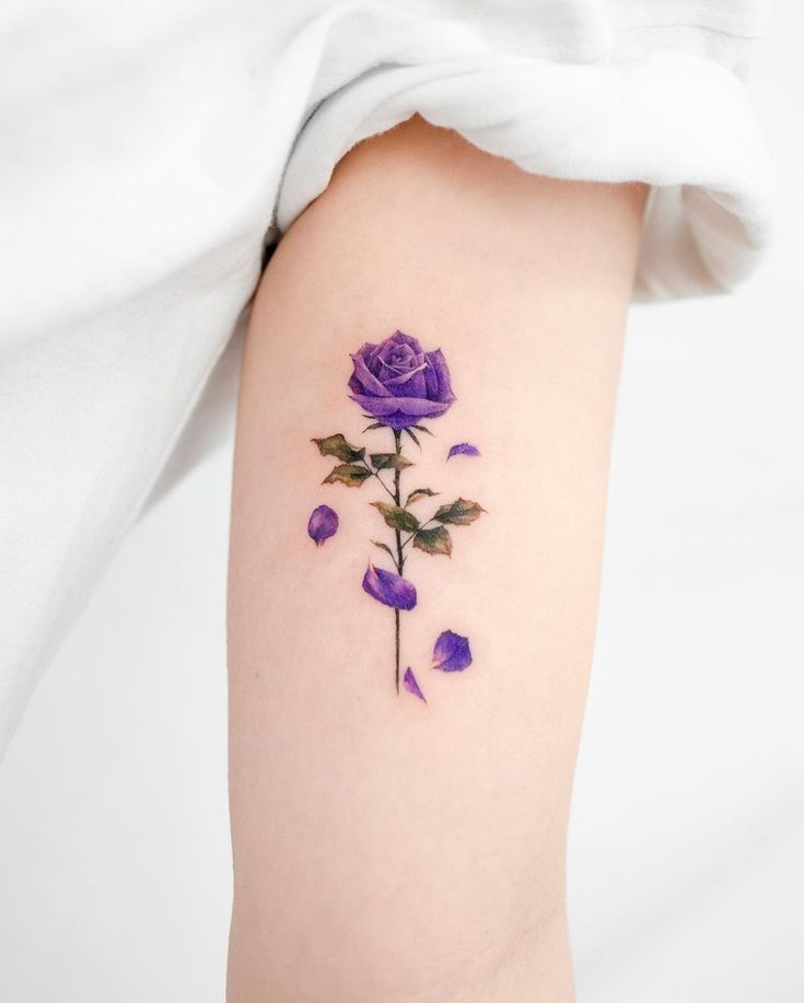 a purple rose tattoo on the right thigh