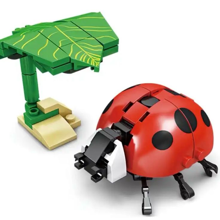 a ladybug toy sitting next to a green table