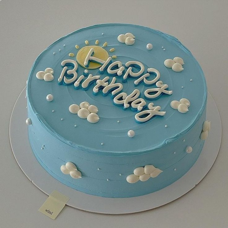 a birthday cake with blue frosting and white decorations