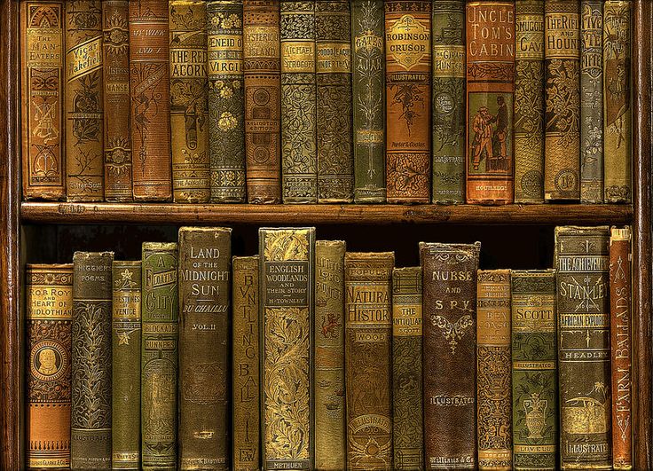 an old book shelf filled with lots of brown and green books on top of each other