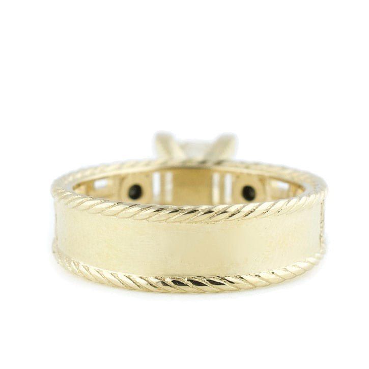 an 18k yellow gold rope band ring with two black diamonds in the center, on a white background