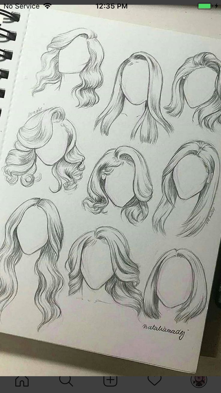 an open notebook with drawings of different hair styles