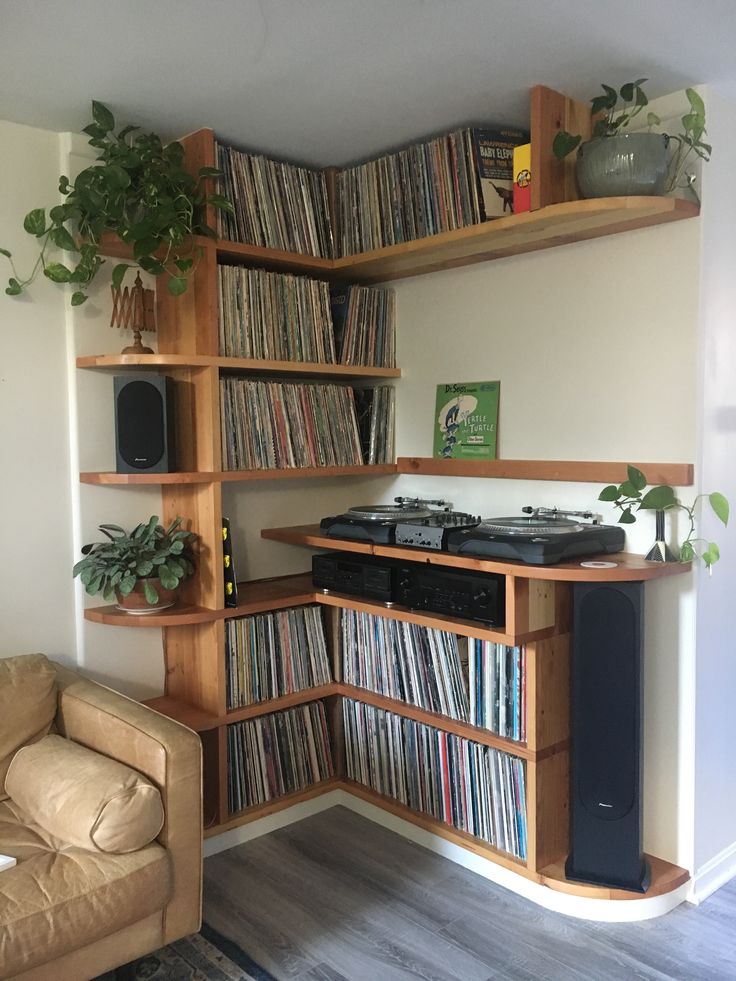 a record player is sitting in front of a shelf full of records