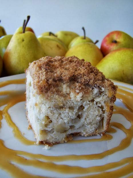 a piece of cake sitting on top of a white plate next to some pears