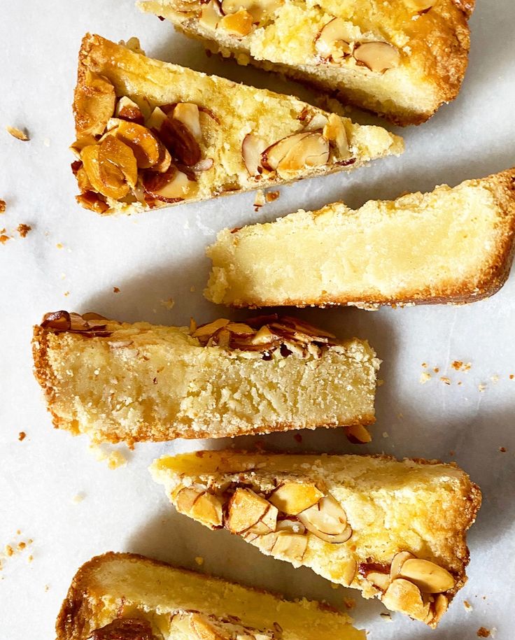 several pieces of cake sitting on top of a white countertop next to each other