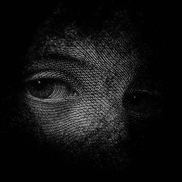 a black and white photo of a person's face with an eye on it