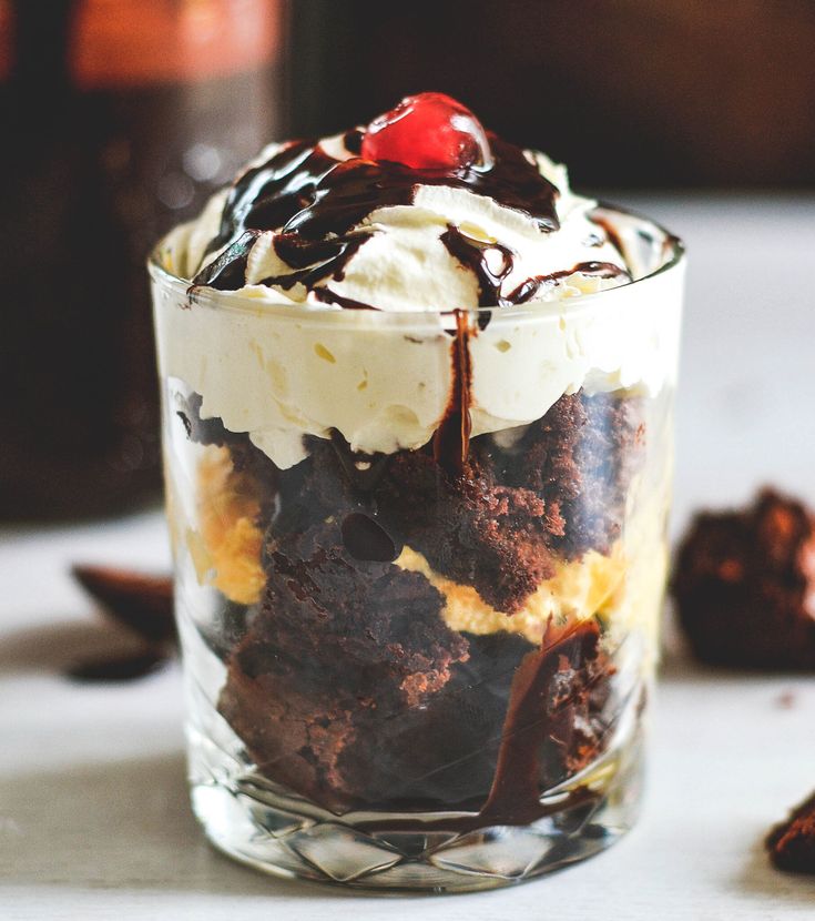 an ice cream sundae with chocolate cookies and cherries