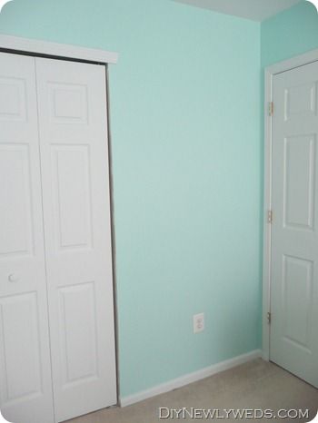 an empty room with blue walls and white doors