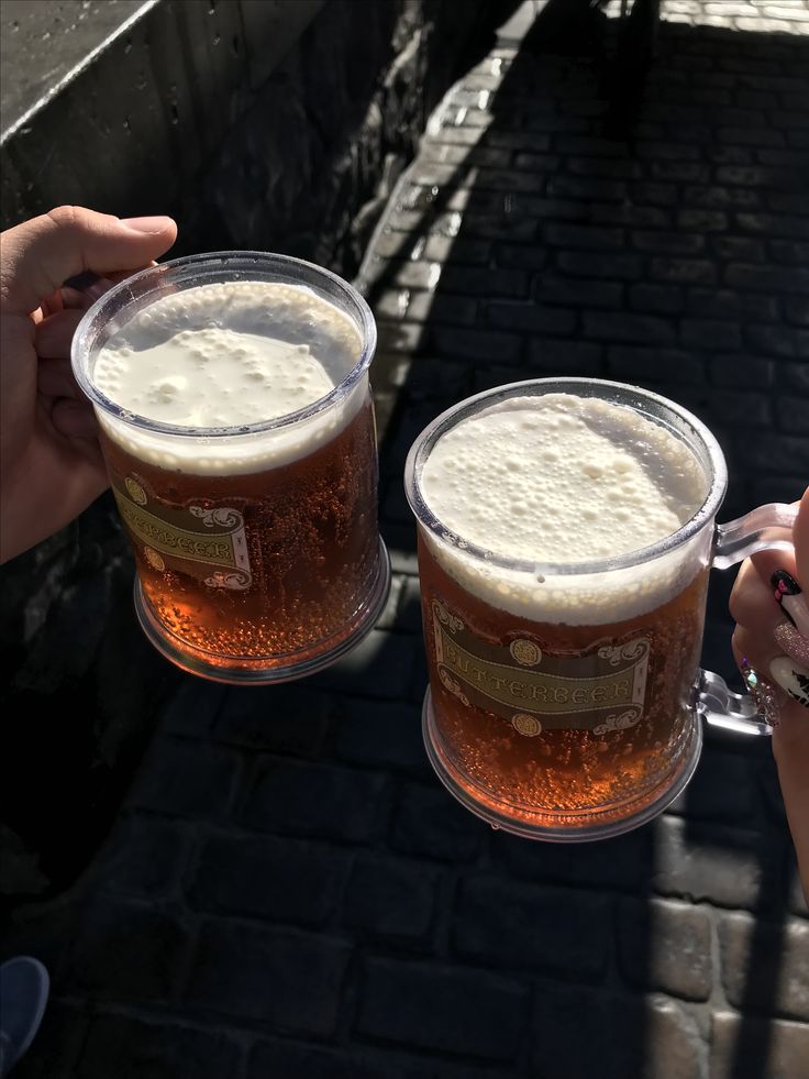 two people toasting with beer in their hands