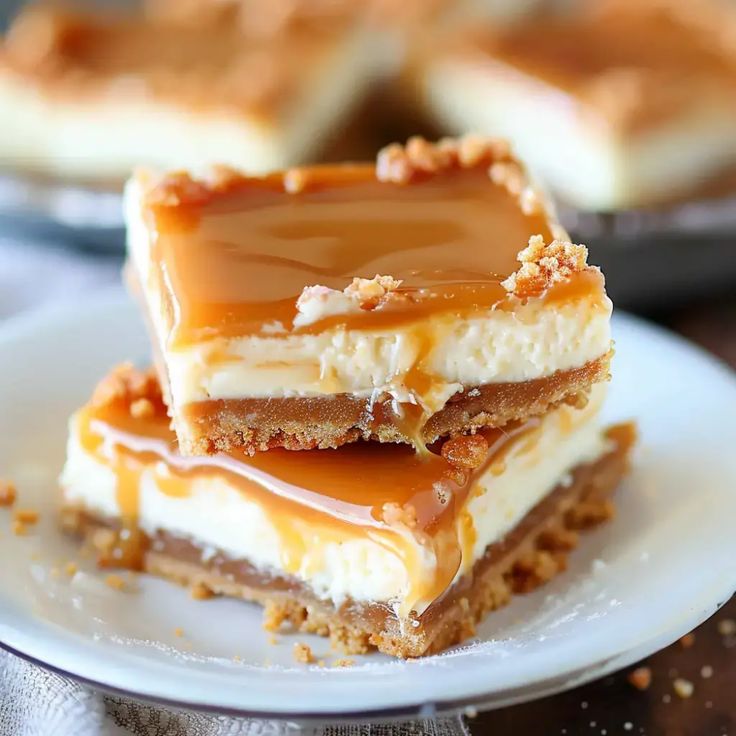 three pieces of dessert sitting on top of a white plate with caramel toppings