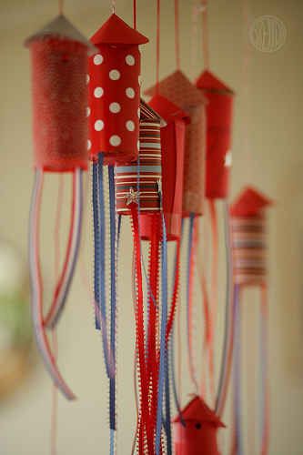 red, white and blue wind chimes hanging from the ceiling