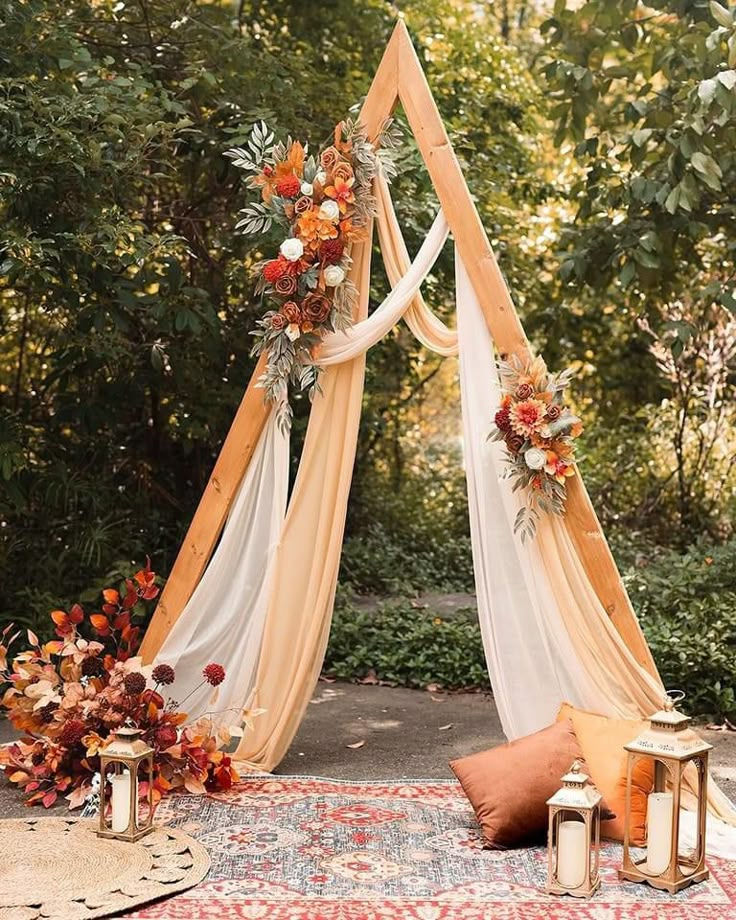 an outdoor wedding setup with flowers, candles and a canopy over the ceremony area is ready for guests to sit down