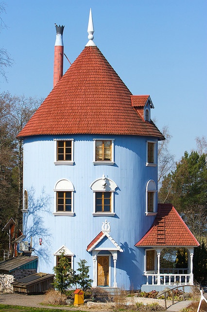 a large blue house with a red roof