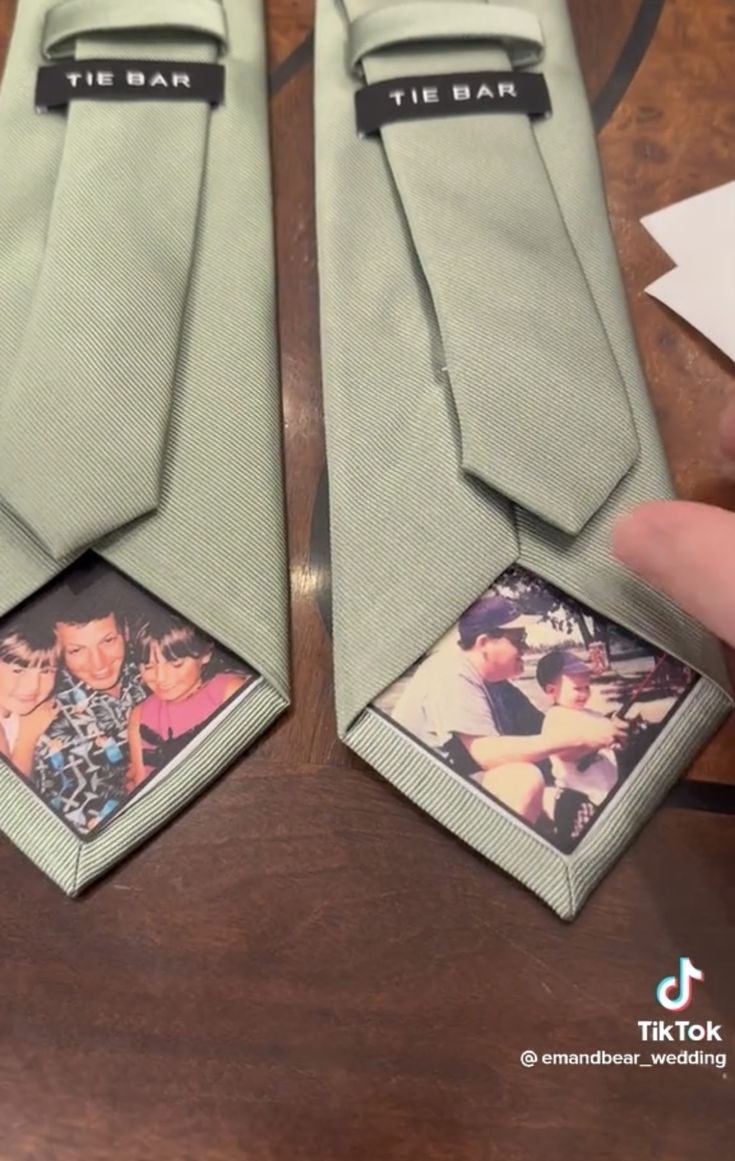 two ties with pictures on them sitting on a table