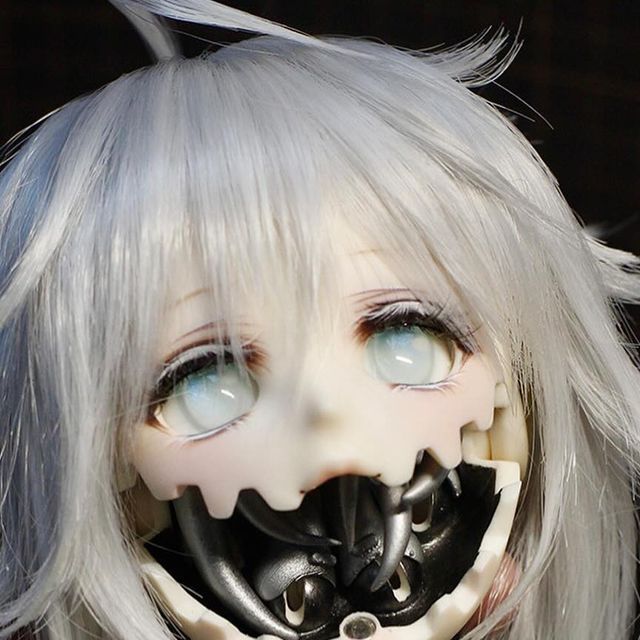 a close up of a doll with white hair and blue eyes wearing a creepy mask