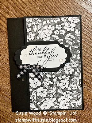 a black and white card with flowers on it