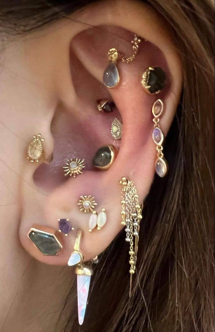 an ear with many different types of piercings on it