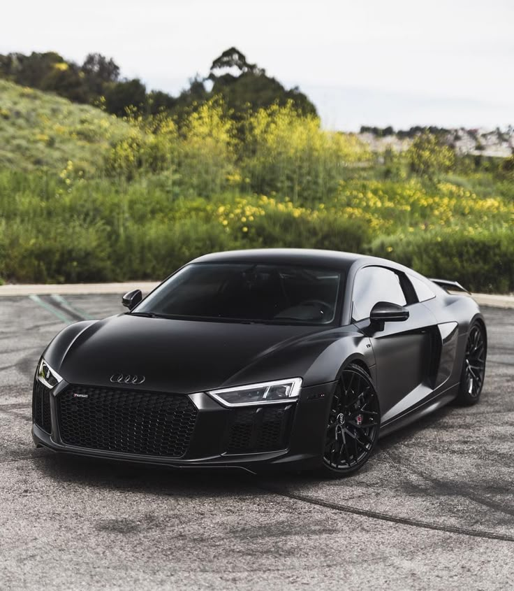 a black sports car parked in a parking lot