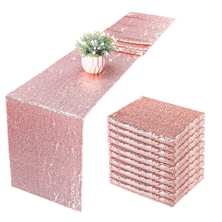 a table with pink sequins on it and a plant in the center, next to each other