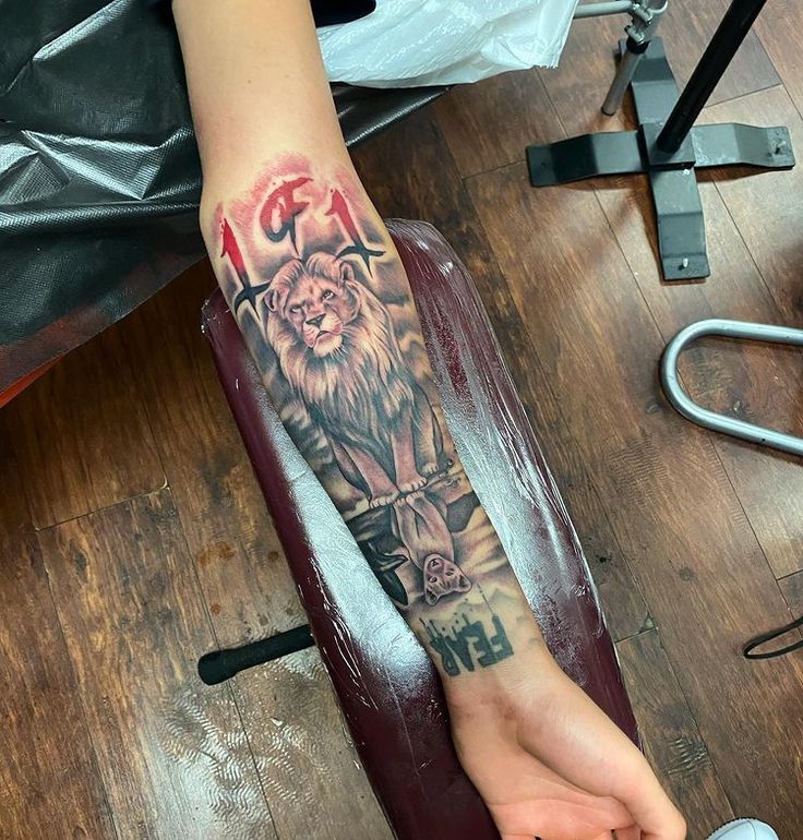 a person with a lion tattoo on their arm