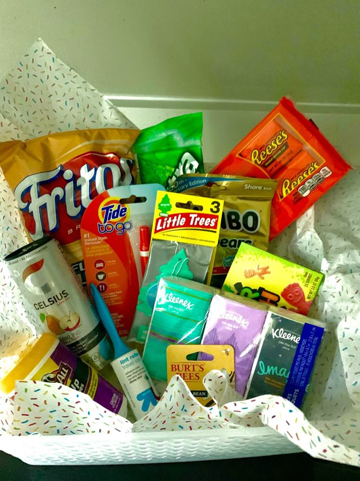 a white basket filled with lots of different types of snacks and confection items