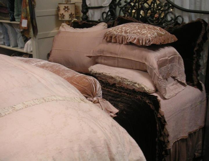 a bed with pillows and blankets on top of it