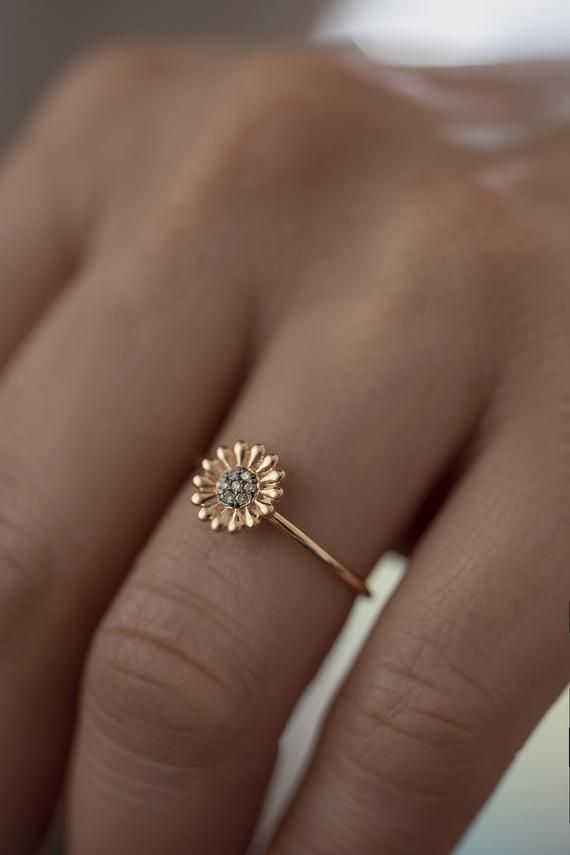 Feeling bohemian?Take this ultra feminine  minimalistic boho daisy ring and declare yourself a champion of laid back cool.Handmade to order in 14K solid Rose Gold with a delicate band, this is not your ordinary daisy motif.Flower power is here to stay and has never looked so good!This is a modern way to wear floral jewelry as imagined by Atelier Petites Pierres, proprietors of beautiful jewelry fashioned from high quality materials and craftsmanship.A fourteen petal design sculpted in light reli Flower Shaped Rose Cut Diamond Jewelry, Heirloom Rose Gold Flower Ring As Promise Ring, Heirloom Rose Gold Flower Ring For Promise, Bohemian Rose Gold Jewelry For Wedding, Heirloom Rose Gold Flower Promise Ring, Rose Gold Flower Ring For Promise, Rose Gold Flower Promise Ring, Delicate Wedding Flower Ring With Charm, Delicate Wedding Flower Ring With Flower Charm