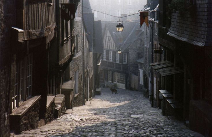 an old cobblestone street is shown in this photo, with buildings on both sides