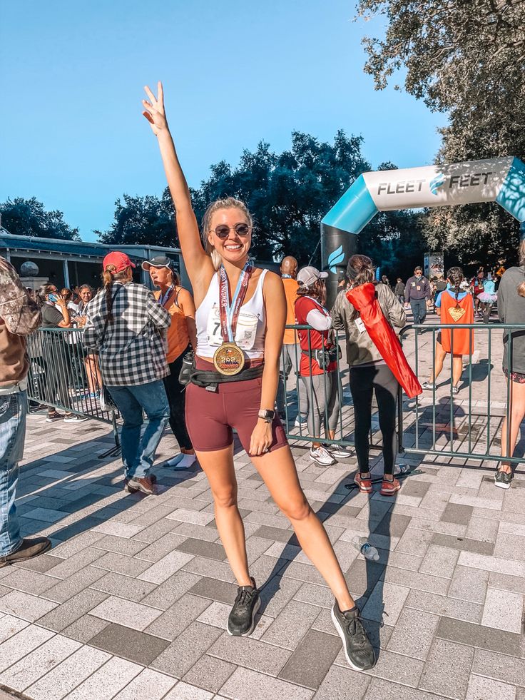 a woman is jumping in the air with her arms up