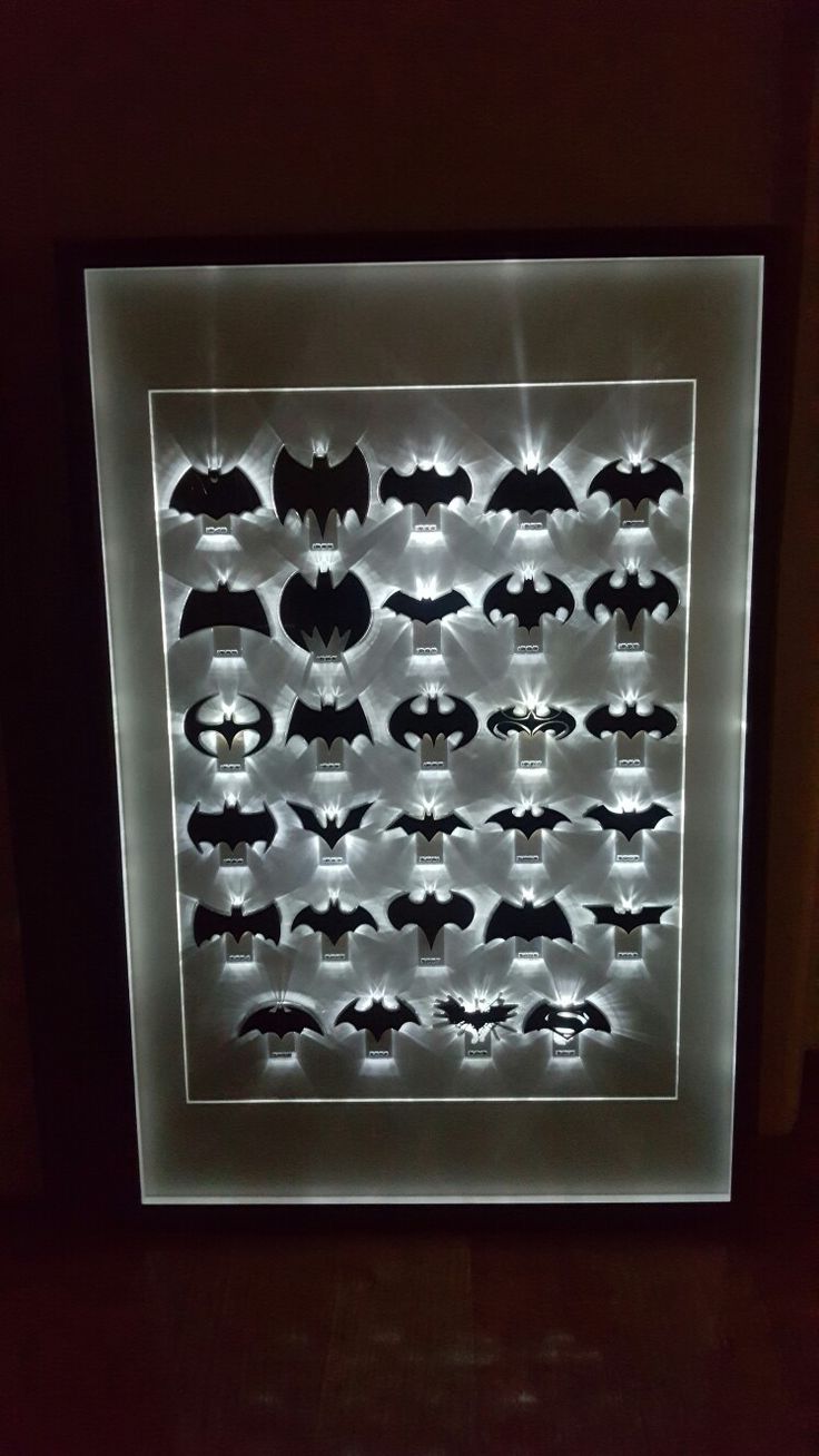 a lighted display case with various bats on it