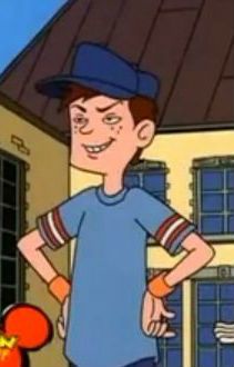 a cartoon boy is standing in front of a house with his hands on his hips