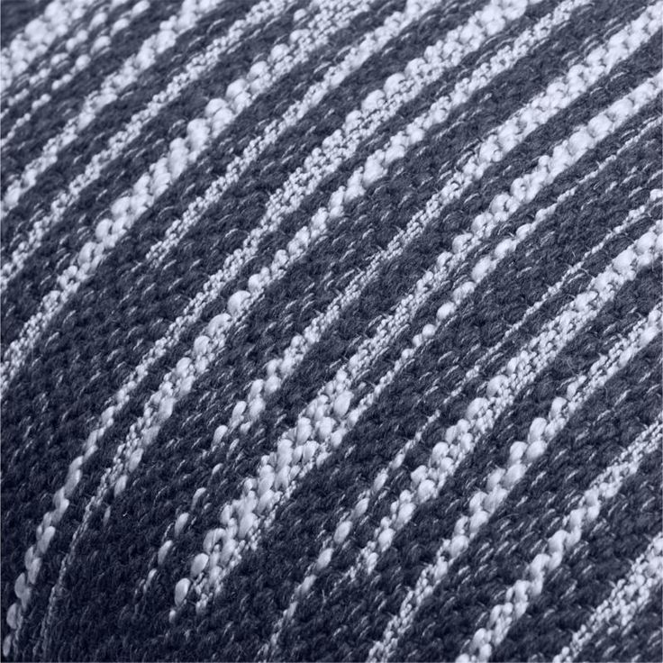 closeup of black and white knitted material with vertical lines in the center, as seen from above