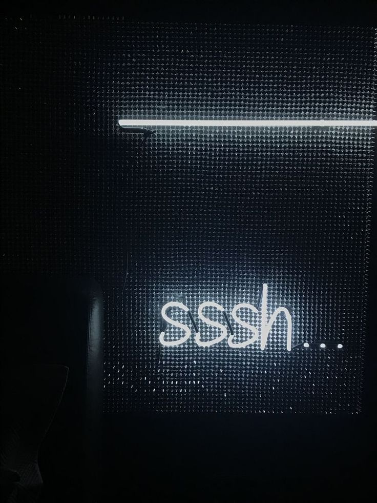 a neon sign with the word nesse written on it in white letters against a black background