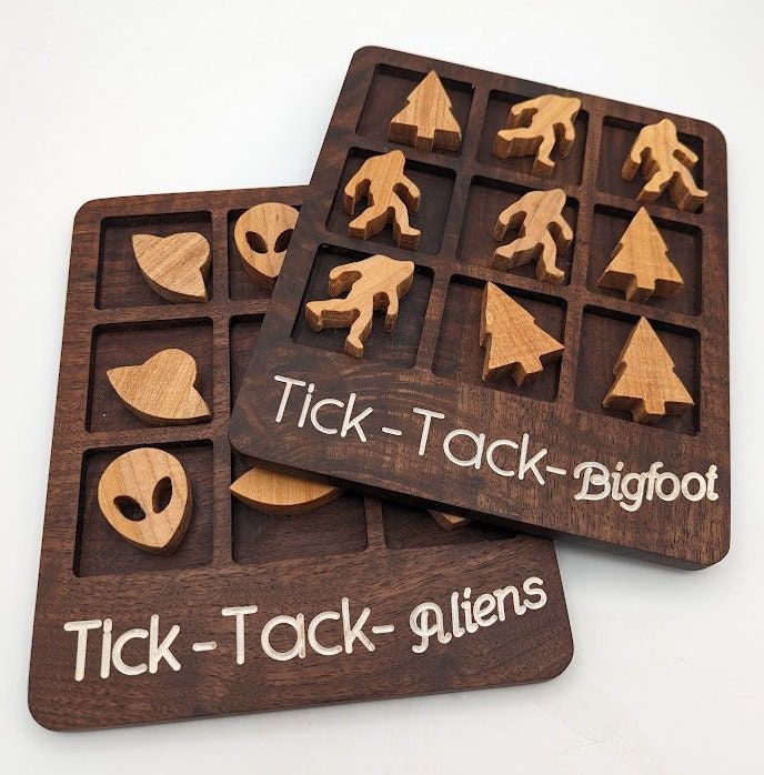 two wooden game pieces with words on them