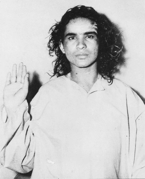 an old black and white photo of a woman holding her hands up