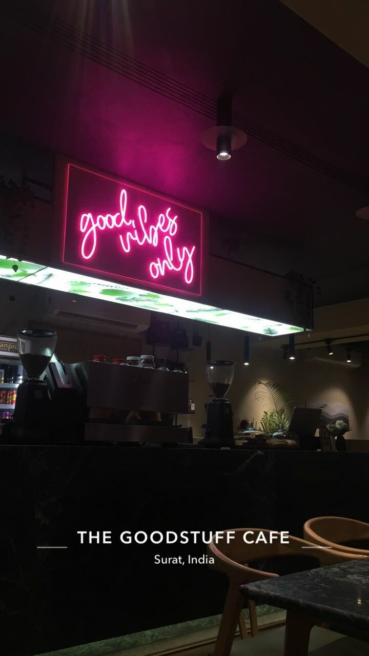 the good stuff cafe is lit up with neon signs and lights above it's counter