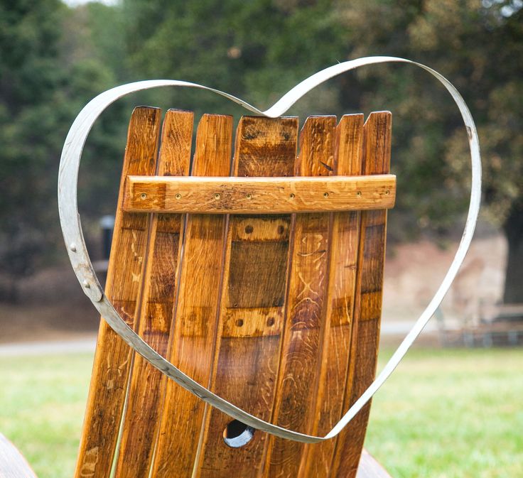 a heart shaped wooden box sitting in the grass