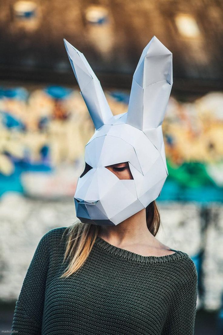 a woman wearing a paper bunny mask