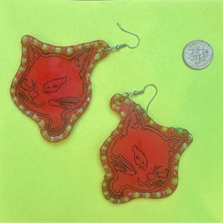 One Of A Kind Handmade Rockabilly Cat Earring. Red Shrinky Dink With Navy Lining Neon New And Gold Glitter Puff Paint. Dime For Size Reference. Support Independent Artist. Cat Earring, Iconic 90s, Shrinky Dink, Puff Paint, Red Earrings, Cat Earrings, Gold Glitter, Red Gold, Independent Artist