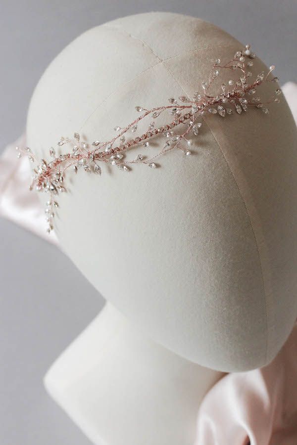 the headpiece is adorned with beads and pearls