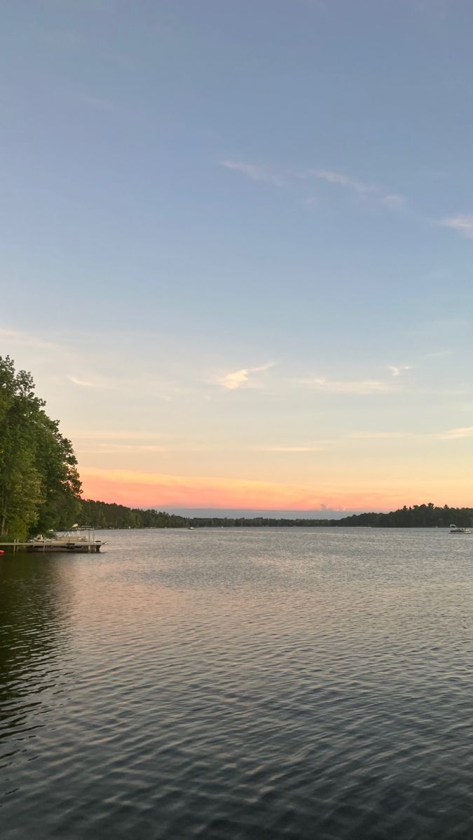 there is a boat on the water at sunset