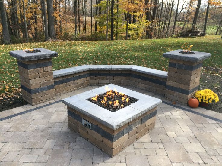 a fire pit sitting on top of a brick patio