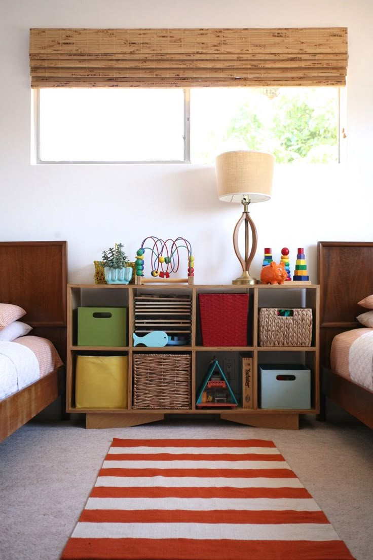 a room with two beds and a rug on the floor