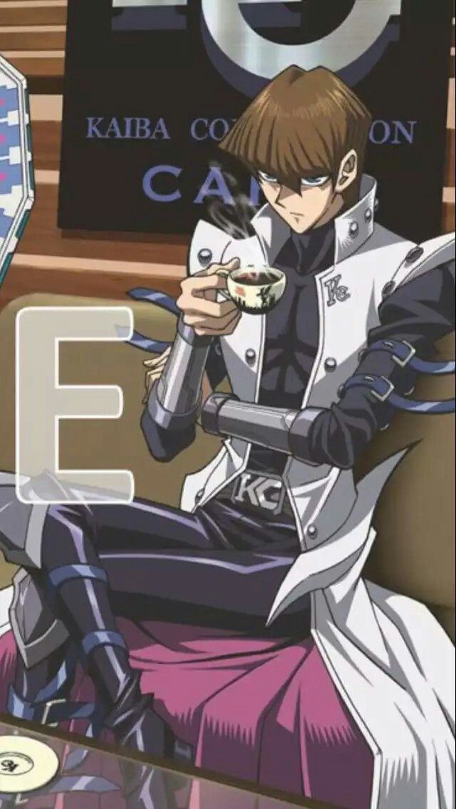 an anime character is sitting on a couch and holding a cell phone in his hand