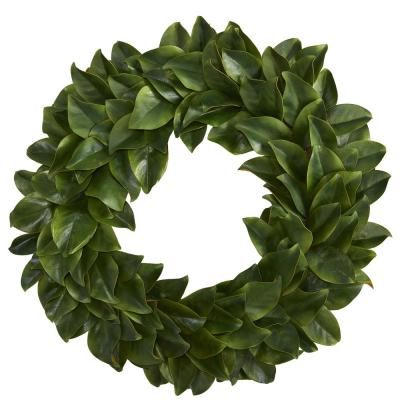 a wreath made out of green leaves on a white background