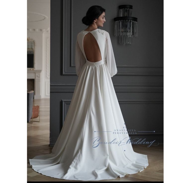 a woman in a white wedding dress looking back