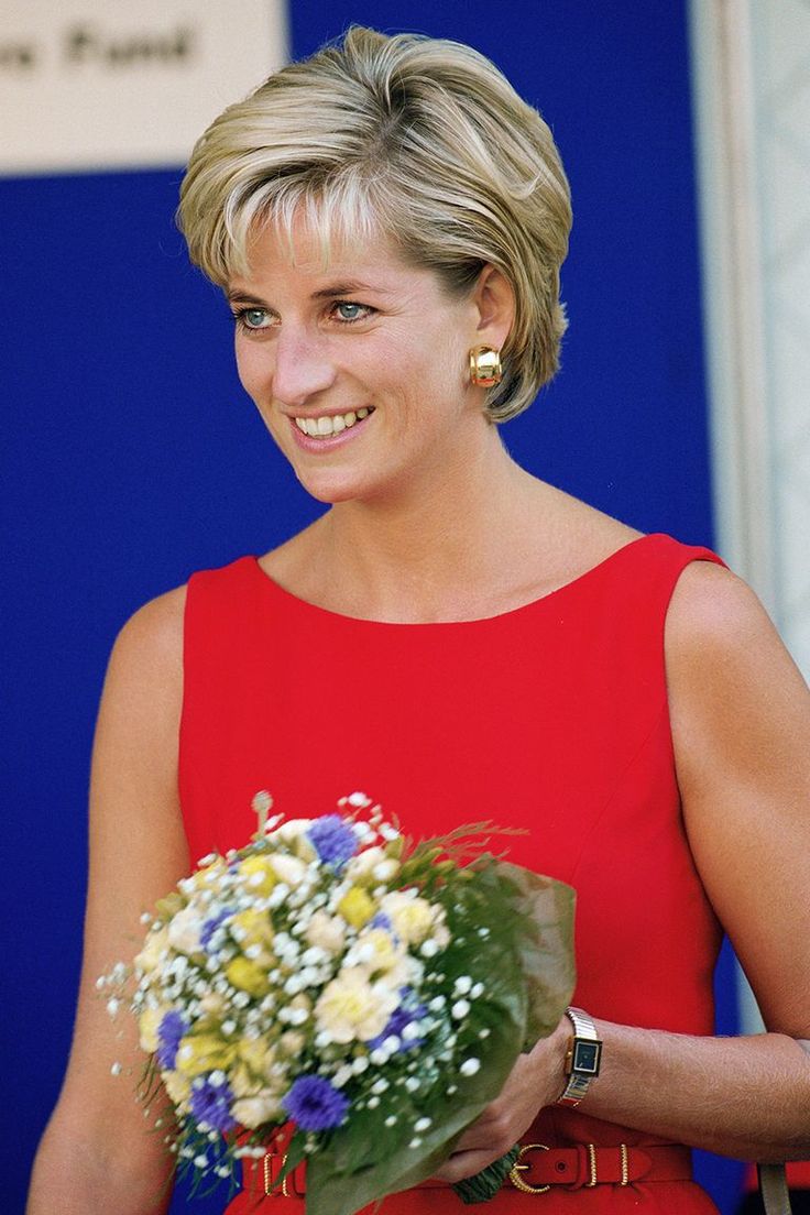 a woman in a red dress holding a bouquet of flowers